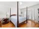 Bedroom featuring a four-poster bed, shutters and wood floors at 1341 Longwood Sw Dr, Marietta, GA 30008