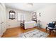 Cozy bedroom with a four-poster bed and hardwood floors at 1341 Longwood Sw Dr, Marietta, GA 30008