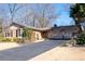 Traditional home featuring a brick facade, manicured lawn and a double garage with an extended driveway at 1341 Longwood Sw Dr, Marietta, GA 30008