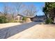 Traditional home featuring a well-manicured lawn, long driveway, a two-car garage, and mature trees at 1341 Longwood Sw Dr, Marietta, GA 30008