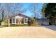 Well-maintained home with bay window, complemented by lush landscaping, mature trees, and a two-car garage at 1341 Longwood Sw Dr, Marietta, GA 30008
