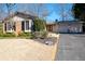 Charming brick home featuring a two-car garage, manicured lawn, and mature trees offering shade at 1341 Longwood Sw Dr, Marietta, GA 30008