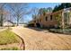 Exterior view of a brick home that features a backyard with walking paths and landscaping at 1341 Longwood Sw Dr, Marietta, GA 30008