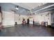 Spacious garage with multiple ceiling fans, storage, and access door at 1341 Longwood Sw Dr, Marietta, GA 30008
