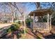A gazebo can be seen in the backyard of this home and is surrounded by nature at 1341 Longwood Sw Dr, Marietta, GA 30008