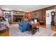 Cozy living room featuring a brick fireplace, built-in bookshelves, and beautiful hardwood floors at 1341 Longwood Sw Dr, Marietta, GA 30008