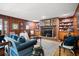 Inviting living room with a brick fireplace, wood paneling, and hardwood floors at 1341 Longwood Sw Dr, Marietta, GA 30008
