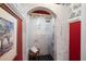 Walk-in shower with marble tile, arched entry, and vintage-style wallpaper at 1341 Longwood Sw Dr, Marietta, GA 30008