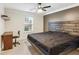 Modern bedroom with a platform bed, plank headboard, desk, and ceiling fan at 1760 Campbell Ives Dr, Lawrenceville, GA 30045