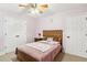 Bedroom with a wood bed frame and plush pillows at 1760 Campbell Ives Dr, Lawrenceville, GA 30045