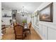 Dining room area with wood floors, a grand chandelier, large windows, and traditional furnishings at 1760 Campbell Ives Dr, Lawrenceville, GA 30045