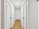 Hallway with neutral walls and flooring, featuring multiple white doors at 1760 Campbell Ives Dr, Lawrenceville, GA 30045
