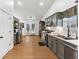 Modern kitchen with sleek gray cabinetry, stainless steel appliances, and wood-look flooring at 1760 Campbell Ives Dr, Lawrenceville, GA 30045