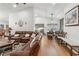 Open-concept living area with hardwood floors connecting the kitchen, dining, and living spaces at 1760 Campbell Ives Dr, Lawrenceville, GA 30045