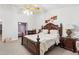 Comfortable main bedroom with white bedding, a nightstand, and an ornate dresser at 1760 Campbell Ives Dr, Lawrenceville, GA 30045