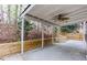 Covered back porch overlooking a cozy backyard with retaining wall at 264 Ascott Ln, Woodstock, GA 30189
