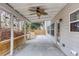 Relax under this covered porch with ceiling fan and views of the fenced-in backyard at 264 Ascott Ln, Woodstock, GA 30189