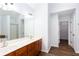 Bathroom featuring a double sink vanity, and access to a walk-in closet at 264 Ascott Ln, Woodstock, GA 30189