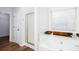 Bright bathroom featuring a large soaking tub, a glass-enclosed shower, and wood-look flooring at 264 Ascott Ln, Woodstock, GA 30189