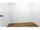 Walk-in closet with wood-look floors and shelving to keep you organized at 264 Ascott Ln, Woodstock, GA 30189