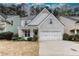 Charming home featuring a brick and shingle facade, well-manicured landscaping, and a two-car garage at 264 Ascott Ln, Woodstock, GA 30189