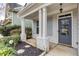Welcoming front porch featuring stately columns, stylish shutters, and a solid front door at 264 Ascott Ln, Woodstock, GA 30189