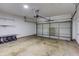 Spacious garage with overhead door, shelving, and plenty of room for storage and parking at 264 Ascott Ln, Woodstock, GA 30189