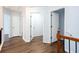Hallway with wood floors leads to bedrooms at 264 Ascott Ln, Woodstock, GA 30189
