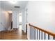 Upstairs hallway features wood floors and access to bedrooms at 264 Ascott Ln, Woodstock, GA 30189