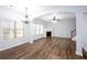 Bright living room with hardwood floors, fireplace, staircase, and large windows at 264 Ascott Ln, Woodstock, GA 30189