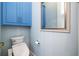 Compact bathroom with a blue cabinet, modern toilet, and framed mirror at 3280 Stillhouse Se Ln # 101, Atlanta, GA 30339