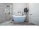 Bright bathroom with a freestanding tub, glass-enclosed shower, and modern fixtures at 3280 Stillhouse Se Ln # 101, Atlanta, GA 30339