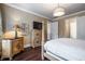 Cozy bedroom with a decorative dresser, TV, and a doorway to the ensuite bathroom at 3280 Stillhouse Se Ln # 101, Atlanta, GA 30339
