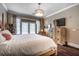 Bright bedroom with a four-poster bed, hardwood floors, and a balcony at 3280 Stillhouse Se Ln # 101, Atlanta, GA 30339