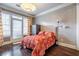 Cozy bedroom with hardwood floors, patio access, and a decorative light fixture at 3280 Stillhouse Se Ln # 101, Atlanta, GA 30339