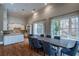 Open-concept dining room features hardwood floors, bright windows, modern chairs and is adjacent to the kitchen at 3280 Stillhouse Se Ln # 101, Atlanta, GA 30339