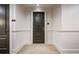 Hallway featuring a dark wood entry door, white molding, and carpeting on the floor at 3280 Stillhouse Se Ln # 101, Atlanta, GA 30339