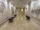 Hallway with neutral-toned walls, tiled floors, recessed lighting, and seating areas along the walls at 3280 Stillhouse Se Ln # 101, Atlanta, GA 30339