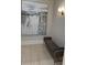 A comfy bench sits below an eye-catching piece of artwork in this neutrally painted hallway at 3280 Stillhouse Se Ln # 101, Atlanta, GA 30339