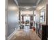 Long hallway featuring stone tile floors, white trim, and an elegant view into the living area at 3280 Stillhouse Se Ln # 101, Atlanta, GA 30339