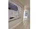 Apartment hallway with neutral colors, artwork, and tile flooring at 3280 Stillhouse Se Ln # 101, Atlanta, GA 30339