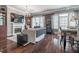 Living room featuring a fireplace, large windows, elegant lighting, hardwood flooring, and dining area at 3280 Stillhouse Se Ln # 101, Atlanta, GA 30339
