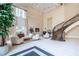 Grand living room with soaring ceilings, fireplace, and curved staircase at 3280 Stillhouse Se Ln # 101, Atlanta, GA 30339
