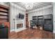 Stylish office with a fireplace, built-in shelving, and hardwood floors at 3280 Stillhouse Se Ln # 101, Atlanta, GA 30339