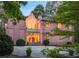 Stunning exterior of pink stucco home showcasing architectural details and manicured landscaping at 4705 Paran Nw Vly, Atlanta, GA 30327