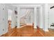 Elegant foyer with staircase, white columns, gray walls, and herringbone wood floor pattern at 4705 Paran Nw Vly, Atlanta, GA 30327