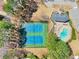 Aerial view of community pool, clubhouse, and tennis courts surrounded by mature trees at 9390 Knollcrest, Alpharetta, GA 30022