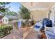 Comfortable back porch with ceiling fan, patio furniture, and view of a well-landscaped lawn at 9390 Knollcrest, Alpharetta, GA 30022