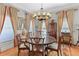 Formal dining room featuring a round table, elegant chairs, and a decorative chandelier at 9390 Knollcrest, Alpharetta, GA 30022