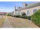 Attractive home showcasing its architectural design, complemented by manicured shrubs and a green lawn at 9390 Knollcrest, Alpharetta, GA 30022